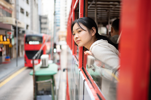 Asian woman taking public transportation