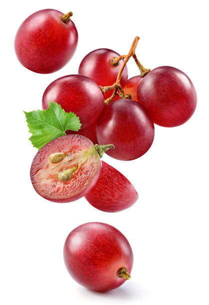 istock Grape isolated. Pink grape with leaves on white background. Violet red grapes flying collection. Full depth of field. 1473140613