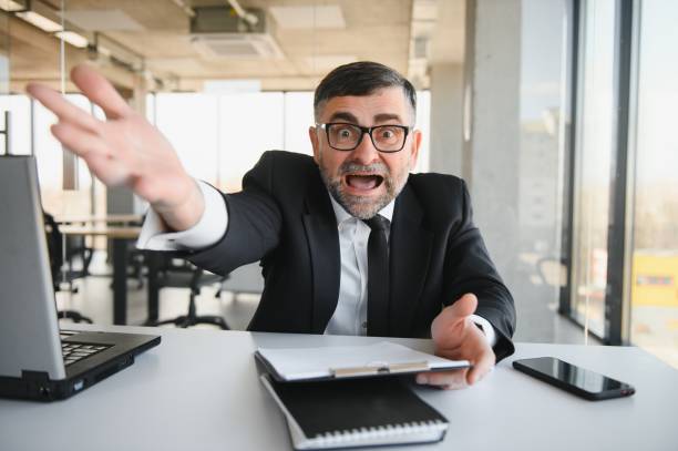 istock Angry businessman with document shouting at somebody 1473141008