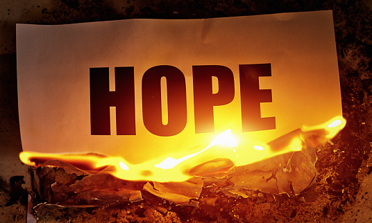 The word HOPE printed in bold type, being consumed by fire.