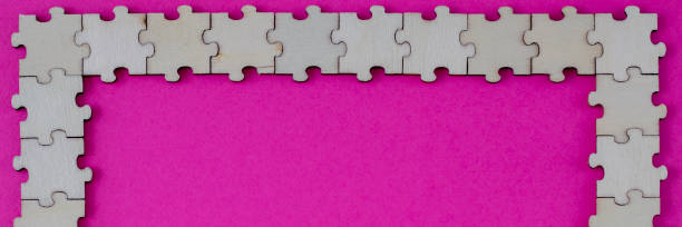 A bright pink banner with wooden frame puzzles.