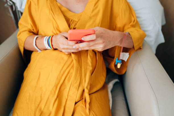 istock Unrecognizable patient using his phone at the clinic day 1473144835