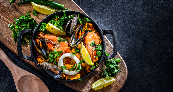 Seafood paella served in a cast iron pan.