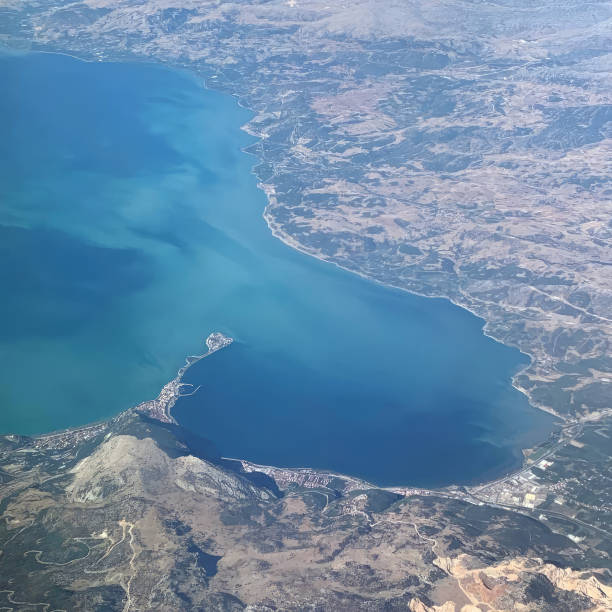 istock Beautiful blue ocean and island, view from an airplane 1473146053