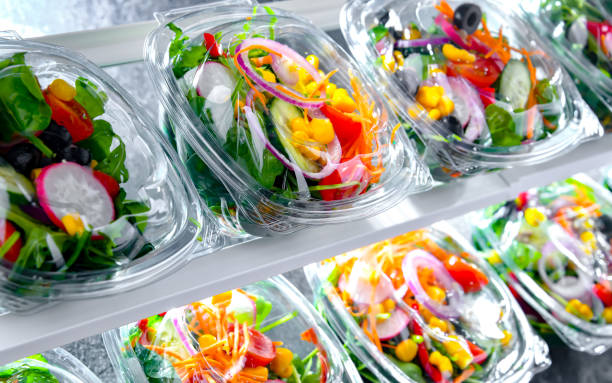 istock Boxes with pre-packaged vegetable salads in a commercial fridge 1473147023