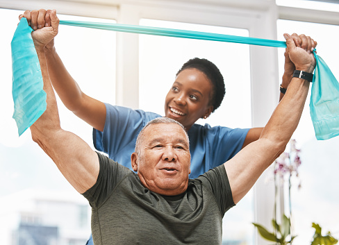 Physiotherapy help, stretching band and doctor with senior man for physical therapy, rehabilitation and healthcare support. Black woman chiropractor or physiotherapy doctor consulting elderly patient
