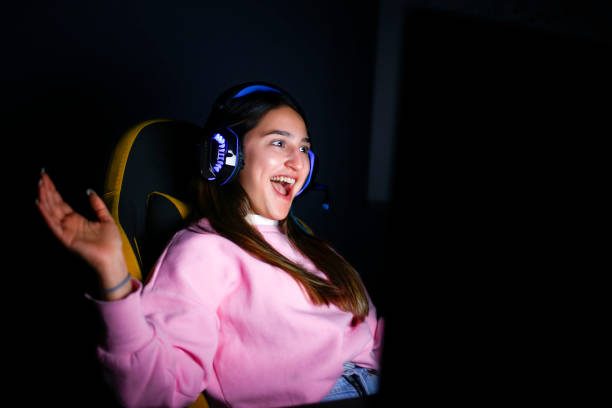 person with headphones happy at computer stock photo