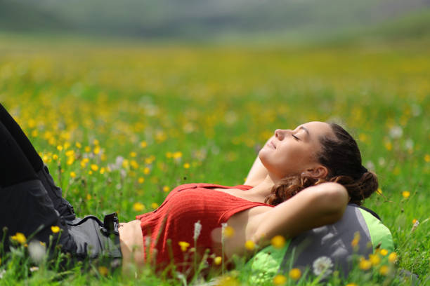 Young woman lying down on the grass