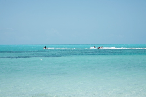 People Riding Personal Watercraft In The Caribbean Sea Off Of The Turks and Caicos Islands.