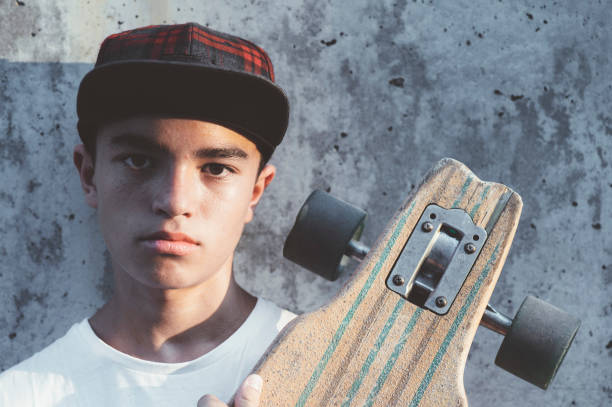istock Boy skater posing with skateboard. 1473153963