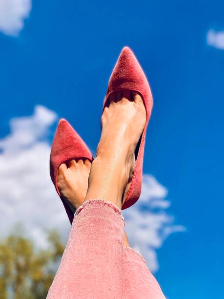 istock feet in shoes against the sky 1473153977