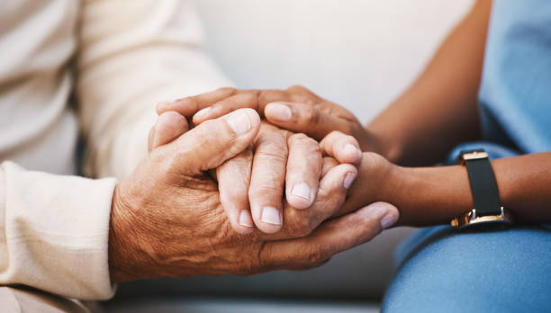 Hands, nurse and doctor with senior patient, empathy and trust for surgery, psychology and healthcare consulting. Closeup psychologist, caregiver and volunteer support, help and hope of mental health stock photo