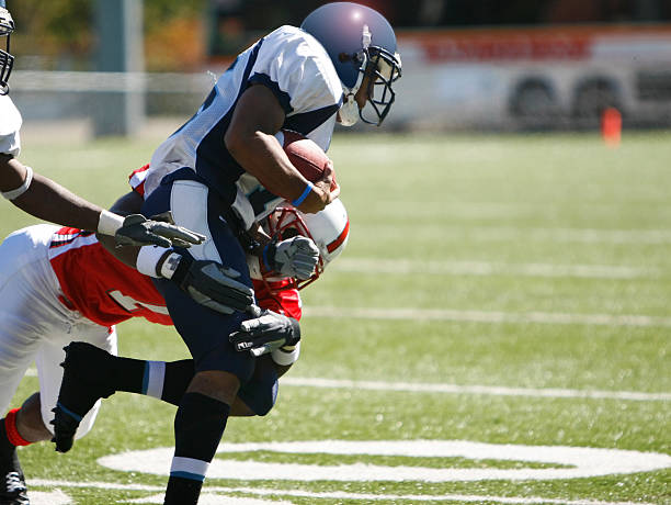 college football tackle - football player american football athlete sport stock-fotos und bilder