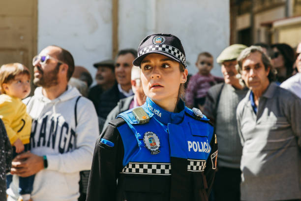A policewoman keeps order during the local city holiday. El Espinar, Spain - March 12, 2023: A policewoman keeps order during the local city holiday "Gabareros". police policewoman women spain stock pictures, royalty-free photos & images
