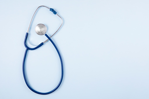 Stethoscope on blue background with copy space