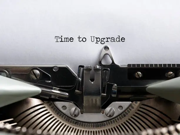 The word time to upgrade written with a vintage typewriter. Technology update concept.