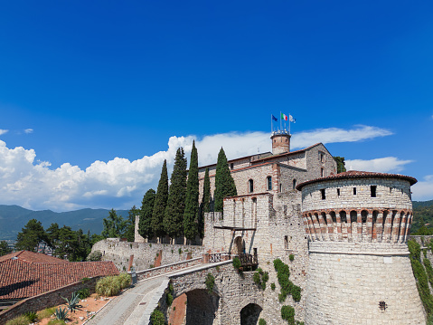 Brescia - Italia. July 05, 2022: Drone view of the main entrance with a drawbridge to the historic castle of the city of Brescia. Lombardy, Italy