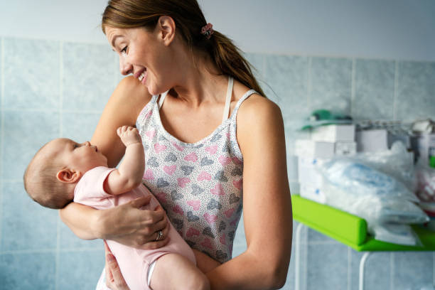 istock Happy mother and baby hugging and playing together. 1473160328