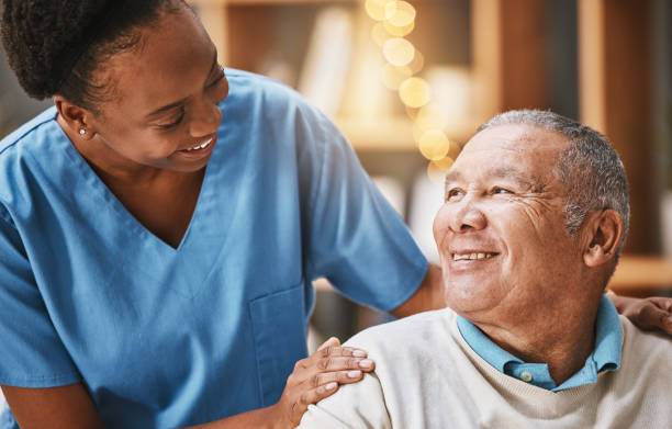 Help, support and medical with nurse and old man for retirement, rehabilitation or healing. Empathy, physical therapy and healthcare with patient and black woman in nursing home for caregiver service stock photo