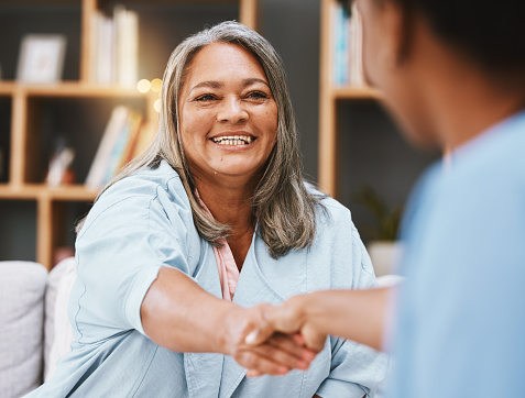 Handshake, healthcare and appointment with a senior woman shaking hands with a female nurse in a retirement home. Thank you, medical and meeting with a mature patient and medicine professional