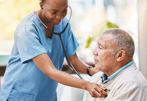 Nurse, senior patient and stethoscope for healthcare service, caregiver career or heart check in hospital, clinic or retirement home. Nursing, consulting and cardiology of elderly man and black woman