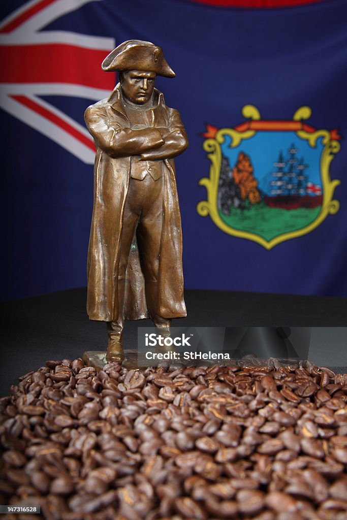 Napoleon's St Helena coffee Napoleon Bonaparte brass statue standing in a sea of coffee beans from St Helena. The emperor praised the coffee when he was exiled on the island. St Helena flag in background  - Canon 5D MKII Coffee - Drink Stock Photo