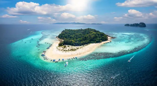 Aerial view of the beautiful Bamboo Island (Koh Mai Phai) with turquoise sea, coral reef and fine sandy beaches, Thailand