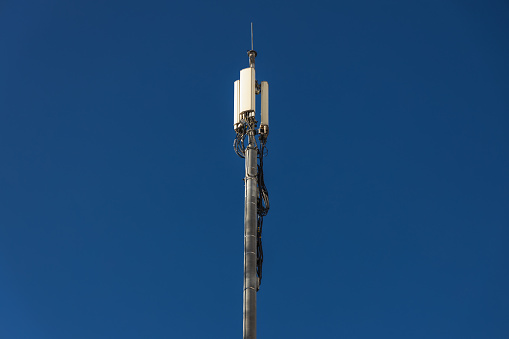 Close up of antenna repeater tower on blue sky. High quality photo