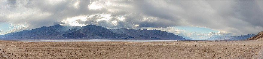death valley landscape in midday heat with soft clouds