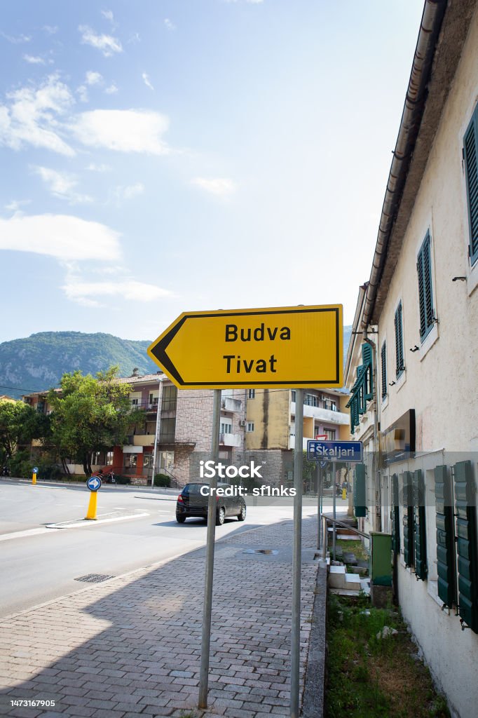 Photo of a road sign with the inscription of the cities of Budva and Tivat 05. 07. 2021 Kotor, Montenegro. Photo of a road sign with the inscription of the cities of Budva and Tivat 05. 07. 2021 Kotor, Montenegro Arrow Symbol Stock Photo