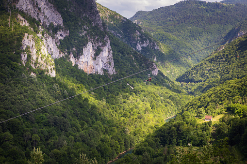 Extreme adrenaline rush in Montenegro, zipline. A steep and high descent above the river, a beautiful view of the canyon opens up