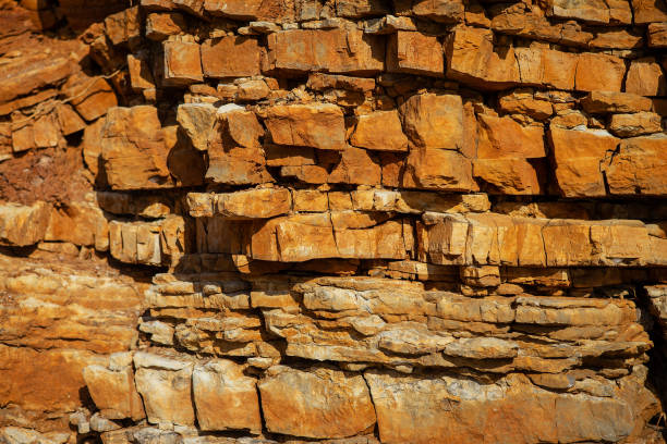 Surface, background, texture of a rock with a brownish-red tint