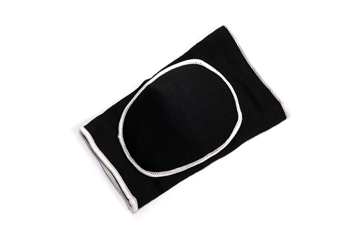 Volleyball or gymnastics elastic protective knee pad isolated on a white