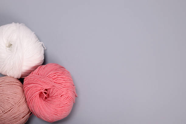 istock Clews of wool threads on a gray background. copy space for text 1473169928