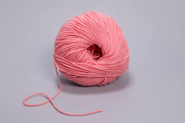 istock Pink ball of wool on a gray background 1473169969