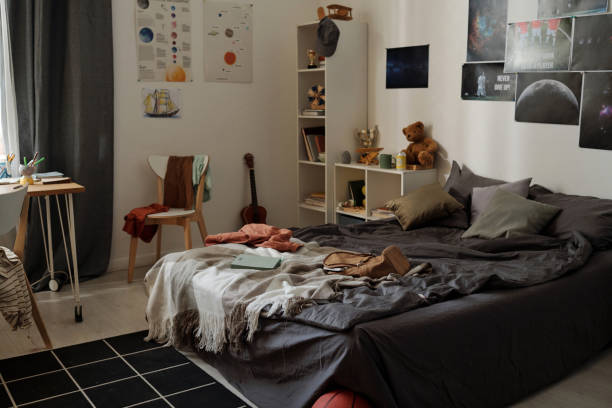istock Messy double bed with cushions, blanket, plaid and backpack 1473173279