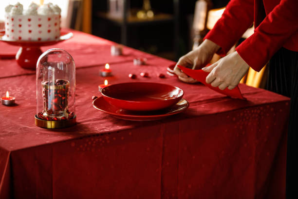 istock Young woman setting the table for Valentine's day celebration 1473176302