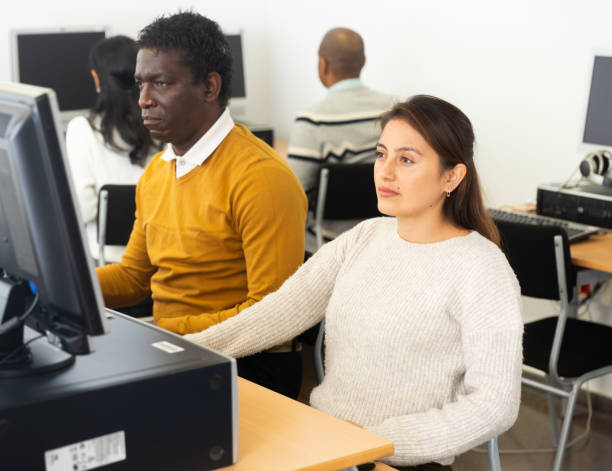 istock Young adult woman studying in computer class 1473176347