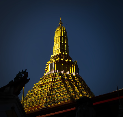 Golden pagoda with blue sky in the temple Bangkok Thailand