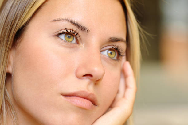 Distracted woman with beautiful eyes stock photo