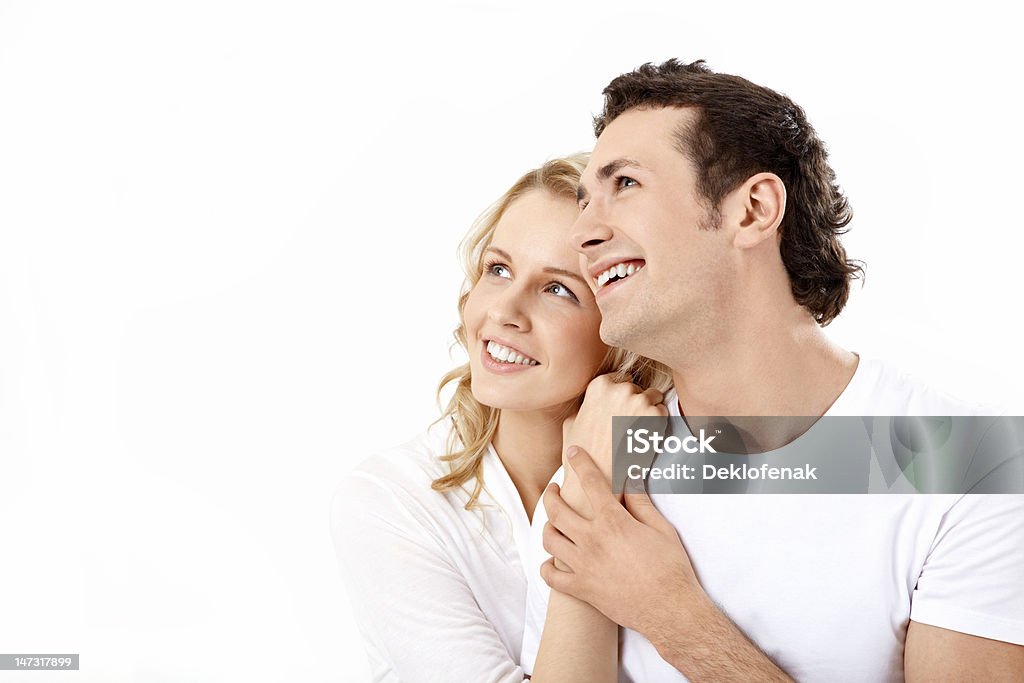Enamoured couple Couple having embraced look afar on a white background 20-29 Years Stock Photo