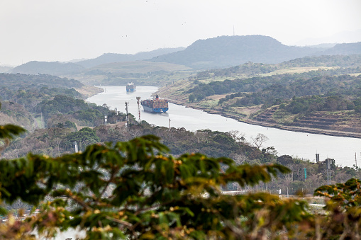 huge container ships driving through the panama canal, panama.
