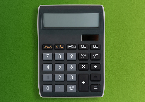 Close up view from above Calculator on green background with copy space for counting and planning