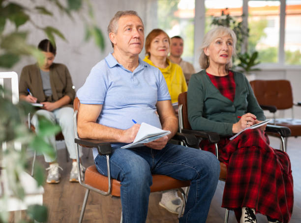 istock Group of older students sitting and listening at lesson 1473181526