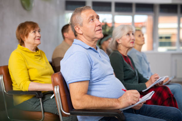 istock Adult students listening in classroom university 1473181536