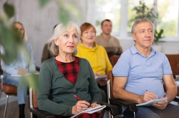 istock Adult students listening in classroom university 1473181636