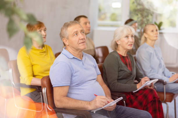 istock Interested elderly man listening lesson during language courses 1473181667
