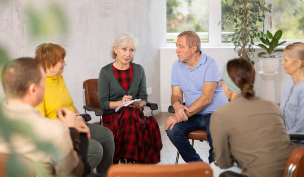 istock Aged woman conducting language speaking club for older adults 1473181716