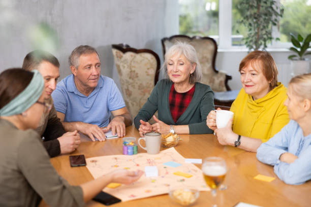 istock Retirees happy  play board games and drink tea with cookies 1473181721