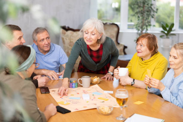 istock Retirees happy  play board games and drink tea with cookies 1473181733